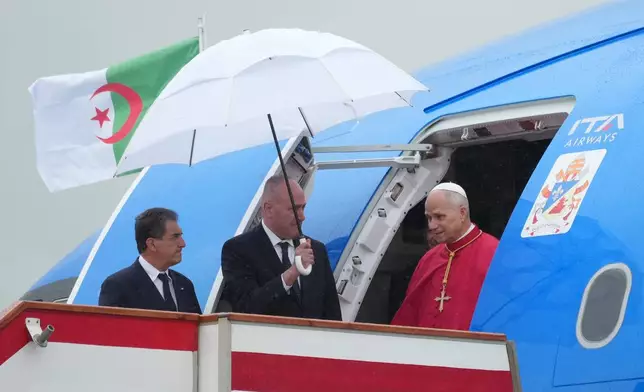 Pope Leo XIV arrives at Algiers' Houari Boumédiène International Airport on Monday, April 13, 2026, at the start of an 11-day apostolic journey to Africa. (AP Photo/Andrew Medichini)