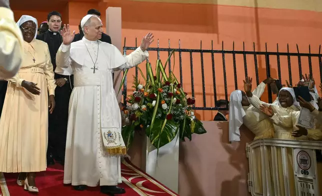 Pope Leo XIV waves to supporters as he leaves after his visit to the Ngul Zamba (Power of God) orphanage in Yaounde, Cameroon, Wednesday April 15, 2026 on the third day of his apostolic journey to Africa. (Alberto Pizzoli, Pool Photo via AP)