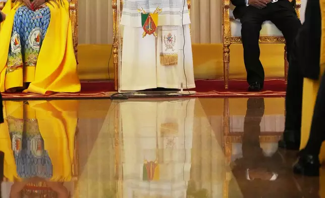 Pope Leo XIV, center, flanked by Cameroon's President Paul Biya and his wife Chantal, meets with the authorities, civil society and the diplomatic corps in Yaounde Cameroon, Wednesday, April 15, 2026. (AP Photo/Andrew Medichini)