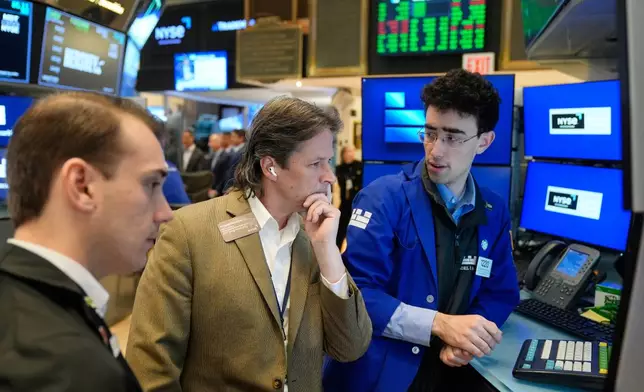 Patrick McKeon, center, works on the floor at the New York Stock Exchange in New York, Tuesday, March 31, 2026. (AP Photo/Seth Wenig)