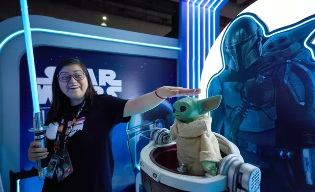 A woman touches Grogu's head at CCXP Mexico in Mexico City, Sunday, April 26, 2026. (AP Photo/Ginnette Riquelme)