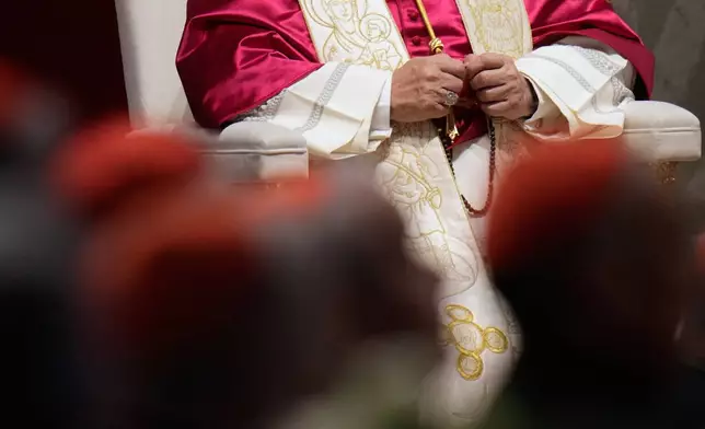 Pope Leo XIV holds a rosary as he leads a vigil for peace inside St. Peter's Basilica at the Vatican, Saturday, April 11, 2026. (AP Photo/Gregorio Borgia)