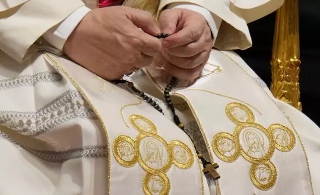 Pope Leo XIV holds a rosary as he leads a vigil for peace inside St. Peter's Basilica at the Vatican, Saturday, April 11, 2026. (AP Photo/Gregorio Borgia)