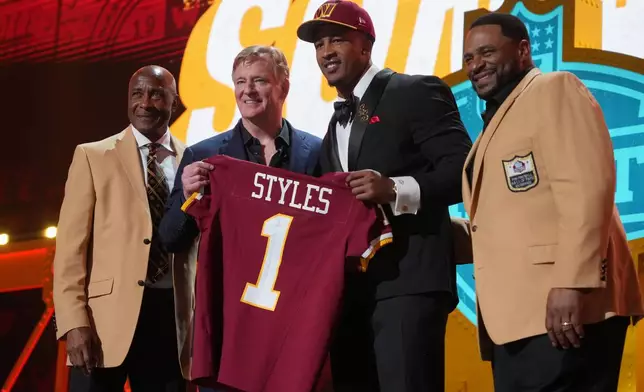 Ohio State linebacker Sonny Styles, center right, poses with NFL Commissioner Roger Goodell after being chosen by the Washington Commanders with the seventh overall pick during the first round of the NFL football draft, Thursday, April 23, 2026, in Pittsburgh. (AP Photo/Gene J. Puskar)