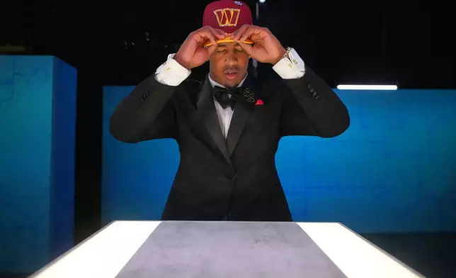 Ohio State linebacker Sonny Styles pauses while putting on a hat after being chosen by the Washington Commanders with the seventh overall pick during the first round of the NFL football draft, Thursday, April 23, 2026, in Pittsburgh. (AP Photo/Jeff Roberson)
