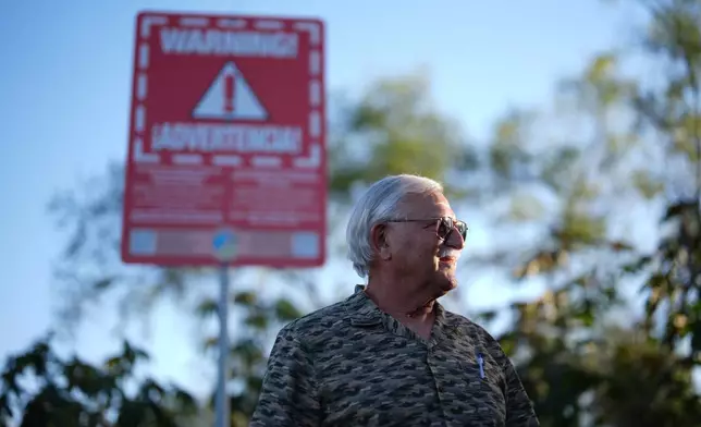 Steve Egger stands near what scientists call "the Saturn hot spot," a section of the Tijuana River where the contaminated water splashes out of pipes and creates pools of foam near his home Friday, March 6, 2026, in San Diego. (AP Photo/Gregory Bull)