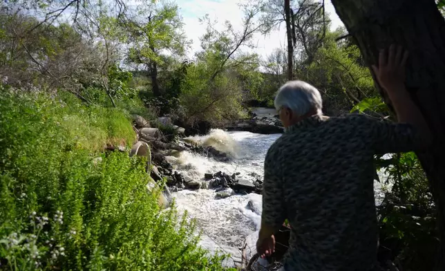 Steve Egger looks over what scientists call "the Saturn hot spot," a section of the Tijuana River where the contaminated water splashes out of pipes and creates pools of foam near his home Friday, March 6, 2026, in San Diego. (AP Photo/Gregory Bull)