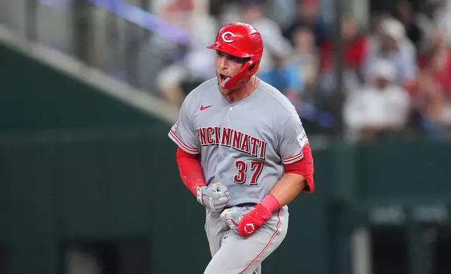 Cincinnati Reds' Tyler Stephenson reacts after hitting a two-run home run off Texas Rangers pitcher Chris Martin during the ninth inning of the Rangers' home-opener baseball game Friday, April 3, 2026, in Arlington, Texas. (AP Photo/Julio Cortez)