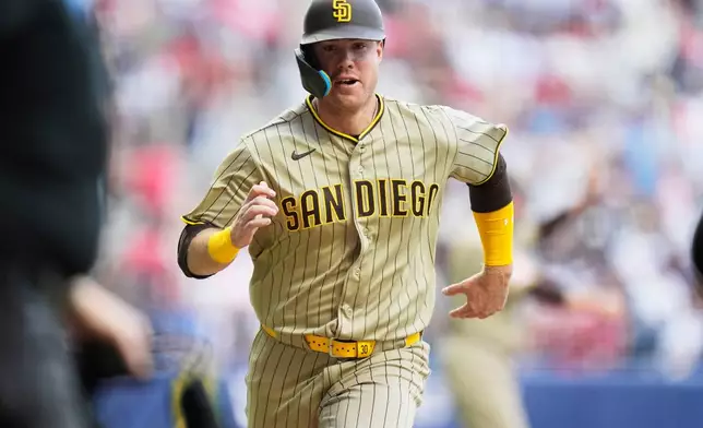 San Diego Padres' Gavin Sheets runs to home plate to score against the Arizona Diamondbacks during the seventh inning of a baseball game in Mexico City, Saturday, April 25, 2026. (AP Photo/Fernando Llano)