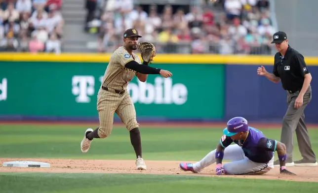 San Diego Padres' Xander Bogaerts, left, throws the ball to first base after tagging Arizona Diamondbacks' Ketel Marte out during the fifth inning of a baseball game in Mexico City, Saturday, April 25, 2026. (AP Photo/Fernando Llano)