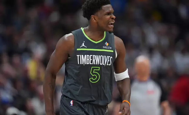 Minnesota Timberwolves guard Anthony Edwards reacts after hitting a 3-point basket against the Denver Nuggets in the first half in Game 1 of a first-round NBA playoffs basketball series, Saturday, April 18, 2026, in Denver. (AP Photo/David Zalubowski)