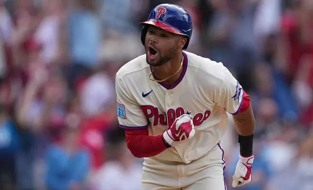 Philadelphia Phillies' Justin Crawford reacts after hitting a one run-single off of Washington Nationals pitcher Cole Henry during the tenth inning of a baseball game, Wednesday, April 1, 2026, in Philadelphia. (AP Photo/Matt Rourke)