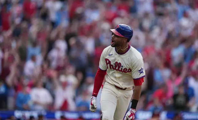Philadelphia Phillies' Justin Crawford reacts after hitting a one run-single off of Washington Nationals pitcher Cole Henry during the tenth inning of a baseball game, Wednesday, April 1, 2026, in Philadelphia. (AP Photo/Matt Rourke)