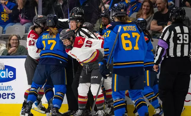 A fight breaks out between the Toronto Sceptres and the Ottawa Charge after the third period during PWHL hockey game action in Toronto, Saturday, April 11, 2026. (Arlyn McAdorey/The Canadian Press via AP)