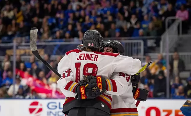 Ottawa Charge forward Brianne Jenner (19) celebrates with teammates after her goal against Toronto Sceptres goaltender Raygan Kirk during third-period PWHL hockey game action in Toronto, Saturday, April 11, 2026. (Arlyn McAdorey/The Canadian Press via AP)