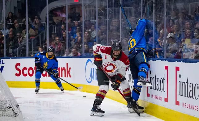 Ottawa Charge defenseman Emma Greco (25) checks Toronto Sceptres forward Blayre Turnbull (40) into the glass during second period of a PWHL hockey game in Toronto, Saturday, April 11, 2026. (Arlyn McAdorey/The Canadian Press via AP)