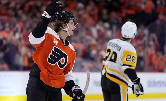 Philadelphia Flyers' Trevor Zegras, left, celebrates past Pittsburgh Penguins' Parker Wotherspoon after scoring a goal during the second period of Game 3 in the first round of the NHL Stanley Cup hockey playoffs Wednesday, April 22, 2026, in Philadelphia. (AP Photo/Matt Slocum)