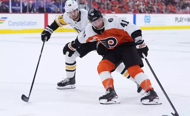 Philadelphia Flyers' Luke Glendening, right, tries to keep the puck away from Pittsburgh Penguins' Parker Wotherspoon during the second period of Game 3 in the first round of the NHL Stanley Cup hockey playoffs Wednesday, April 22, 2026, in Philadelphia. (AP Photo/Matt Slocum)