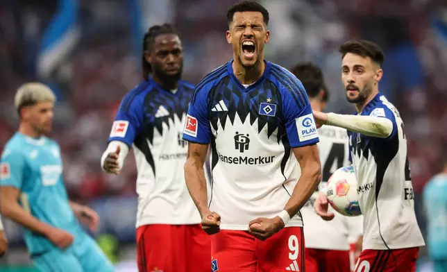 Hamburg's Robert Glatzel, front, celebrates after scoring his side's first goal during the German Bundesliga soccer match between Hamburger SV and TSG 1899 Hoffenheim in Hamburg, Germany, Saturday, April 25, 2026. (Christian Charisius/dpa via AP)