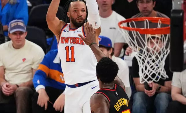 New York Knicks' Jalen Brunson (11) shoots over Atlanta Hawks' Onyeka Okongwu (17) during the first half in Game 1 of a first-round NBA playoffs basketball series, Saturday, April 18, 2026, in New York. (AP Photo/Frank Franklin II)