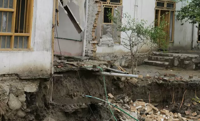 Residents inspect a building that partially collapsed due to heavy flooding in Jalalabad, Afghanistan, Saturday, April 4, 2026. (AP Photo/Wahidullah Kakar)