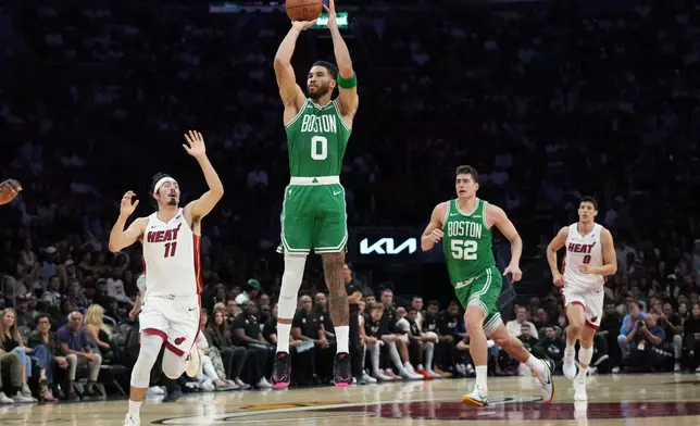Boston Celtics forward Jayson Tatum (0) shoots a three-pointer during the first half of an NBA basketball game against the Miami Heat, Wednesday, April 1, 2026, in Miami. (AP Photo/Lynne Sladky)