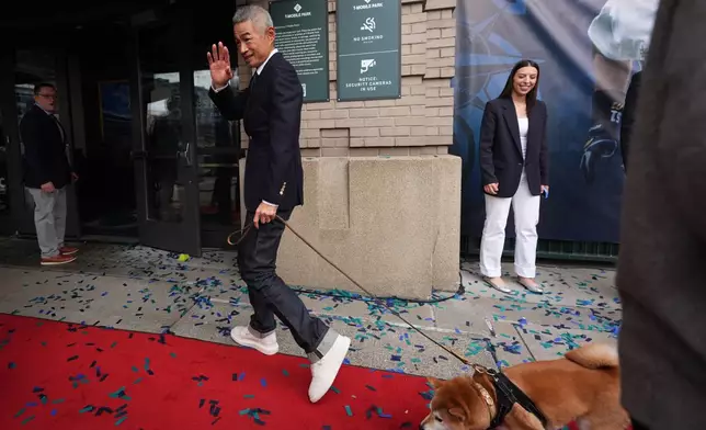 Former Seattle Mariners right fielder Ichiro Suzuki departs with his dog Kikyu after the unveiling ceremony for his statue outside of T-Mobile Park, Friday, April 10, 2026, in Seattle. (AP Photo/Lindsey Wasson)