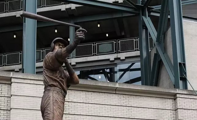 The bat on the statue of former Seattle Mariners right fielder Ichiro Suzuki is broken during the unveiling ceremony outside of T-Mobile Park, Friday, April 10, 2026, in Seattle. (AP Photo/Lindsey Wasson)