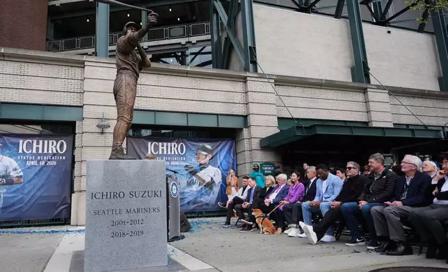 A broken bat is seen on the statue of former Seattle Mariners right fielder Ichiro Suzuki during an unveiling ceremony outside of T-Mobile Park, Friday, April 10, 2026, in Seattle. (AP Photo/Lindsey Wasson)