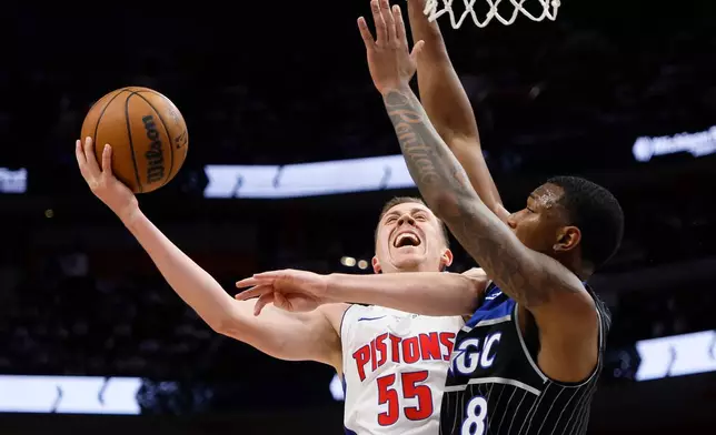 Detroit Pistons forward Duncan Robinson (55) goes to the basket against Orlando Magic forward Jamal Cain (8) during the first half in Game 2 of a first-round NBA basketball playoffs series Wednesday, April 22, 2026, in Detroit. (AP Photo/Duane Burleson)