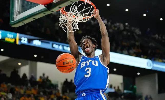 FILE - BYU forward AJ Dybantsa dunks in the first half of an NCAA college basketball game against Baylor Tuesday, Feb. 10, 2026, in Waco, Texas. (AP Photo/Tony Gutierrez, File