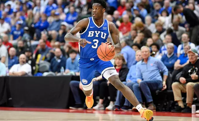 FILE - BYU forward AJ Dybantsa (3) drives to the basket against Dayton during the first half of an NCAA college basketball game, Friday, Nov. 28, 2025, in Kissimmee, Fla. (AP Photo/Phelan M. Ebenhack, File)