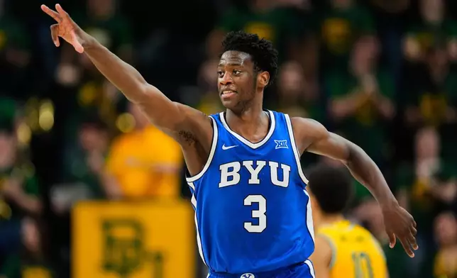 FILE - BYU forward AJ Dybantsa celebrates his three-pointer in the second half of an NCAA college basketball game against Baylor Tuesday, Feb. 10, 2026, in Waco, Texas. (AP Photo/Tony Gutierrez, File)