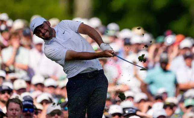Scottie Scheffler hits his tee shot on the 12th hole during the final round of the Masters golf tournament at the Augusta National Golf Club, Sunday, April 12, 2026, in Augusta, Ga. (AP Photo/Gerald Herbert)