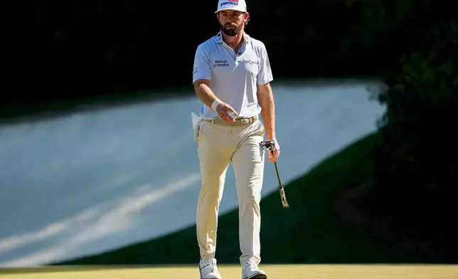 Cameron Young waves after his putt on the 13th hole during the third round of the Masters golf tournament at the Augusta National Golf Club, Saturday, April 11, 2026, in Augusta, Ga. (AP Photo/Ashley Landis)