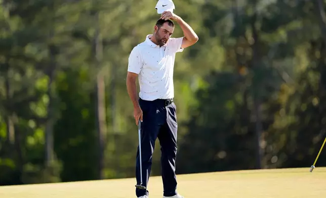 Scottie Scheffler finishes his final round of the Masters golf tournament at the Augusta National Golf Club, Sunday, April 12, 2026, in Augusta, Ga. (AP Photo/David J. Phillip)