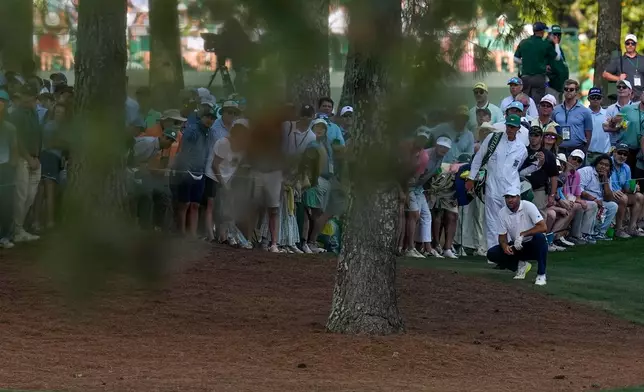 Scottie Scheffler watches his shot on the 15th hole during the final round of the Masters golf tournament at the Augusta National Golf Club, Sunday, April 12, 2026, in Augusta, Ga. (AP Photo/Eric Gay)