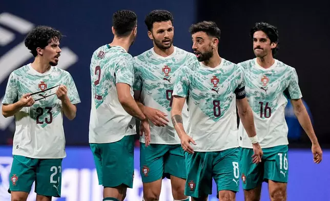 Portugal team mates celebrate a goal against the USA during the first half of an international friendly soccer match, Tuesday, March 31, 2026, in Atlanta. (AP Photo/Mike Stewart)