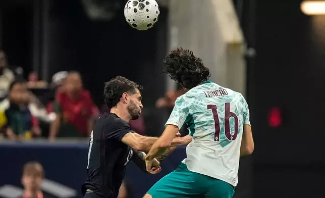 USA's Christian Pulisic (10) and Portugal's Francisco Trincao work during the first half of an international friendly soccer match, Tuesday, March 31, 2026, in Atlanta. (AP Photo/Mike Stewart)