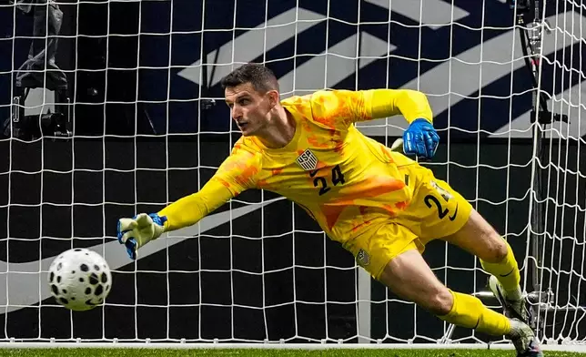 USA goalkeeper Matt Freese (24) misses the ball as Portugal's Francisco Trincao scores a goal during the first half of an international friendly soccer match, Tuesday, March 31, 2026, in Atlanta. (AP Photo/Mike Stewart)