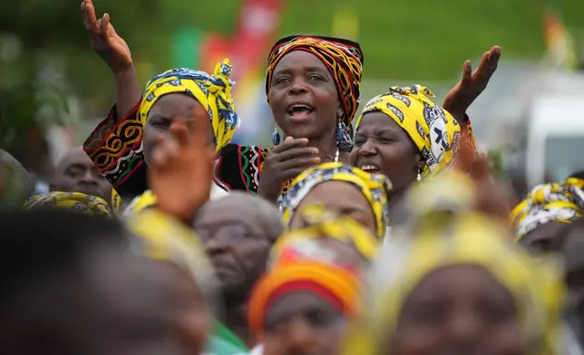 A woman prays during a Mass celebrated by Pope Leo XIV at Bamenda Airport, Cameroon, Thursday, April 16, 2026, on the fourth day of his 11-day pastoral visit to Africa. (AP Photo/Andrew Medichini)
