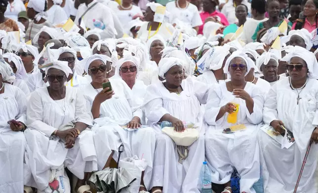 Faithful wait for Pope Leo XIV in the Japoma Stadium before the start of a Mass, in Douala, Cameroon, Friday, April 17, 2026 on the fifth day of his 11-day pastoral visit to Africa. (AP Photo/Andrew Medichini)