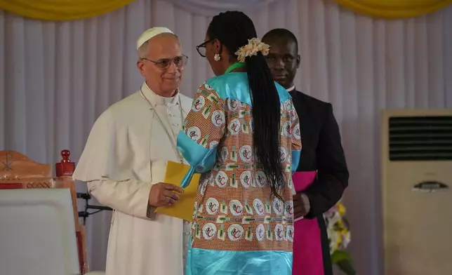 Pope Leo XIV talks with a student during a meeting at the Catholic University of Central Africa, in Yaounde Cameroon, Friday, April 17, 2026. (AP Photo/Andrew Medichini)
