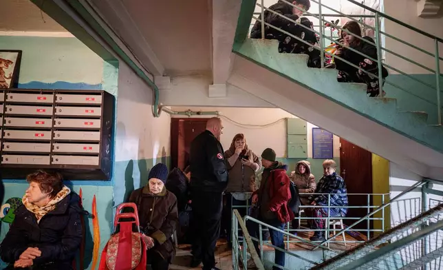 People take shelter inside a house damaged after a Russian strike on residential area in Kyiv, Ukraine, on Thursday, April 16, 2026. (AP Photo/Evgeniy Maloletka)