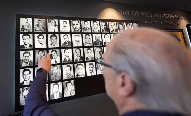 Bay of Pigs veteran Francisco J. Hernandez points out fellow Brigade 2506 members he knew personally who were killed in the 1961 invasion as the Bay of Pigs Museum prepares to reopen in a new and larger space, in Miami's Little Havana neighborhood., Tuesday, April 7, 2026. (AP Photo/Rebecca Blackwell)
