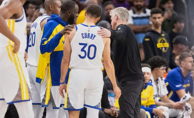 Golden State Warriors forward Draymond Green (23), guard Stephen Curry (30) and head coach Steve Kerr are seen together in closing minutes of their NBA play-in tournament game against the Phoenix Suns at Mortgage Matchup Center in Phoenix, Ariz., Friday, April 17, 2026. (Stephen Lam/San Francisco Chronicle via AP)