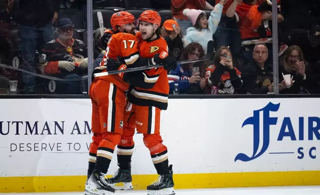 Anaheim Ducks left wing Cutter Gauthier, right, celebrates his goal with left wing Alex Killorn during the third period of an NHL hockey game against the Vancouver Canucks, Sunday, April 12, 2026, in Anaheim, Calif. (AP Photo/Kyusung Gong)