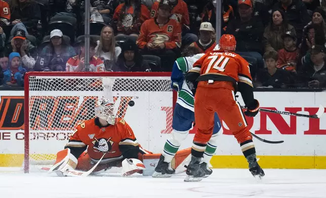 The shot by Vancouver Canucks right wing Brock Boeser goes past Anaheim Ducks goaltender Lukas Dostal, left, during the third period of an NHL hockey game, Sunday, April 12, 2026, in Anaheim, Calif. (AP Photo/Kyusung Gong)