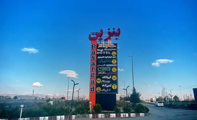 A sign for a roadside hotel is seen on Road 2 near Golhahr, Iran, Thursday, April 9, 2026. (AP Photo/Francisco Seco)