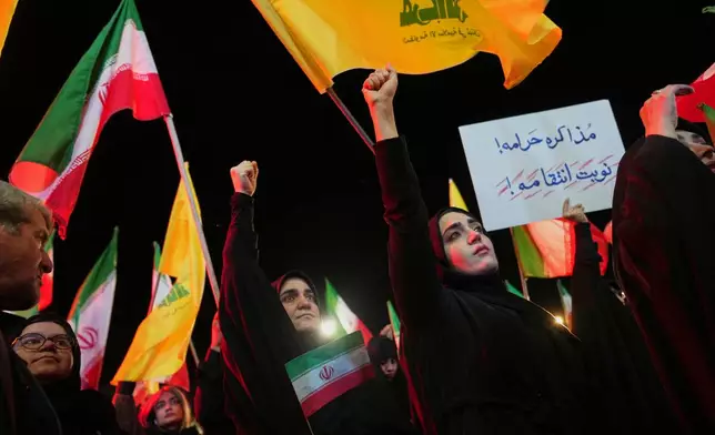 Government supporters gather ahead of the funeral procession for Maj. Gen. Majid Khademi, head of intelligence for Iran's paramilitary Revolutionary Guard, in Tehran, Iran, Wednesday, April 8, 2026. (AP Photo/Francisco Seco)